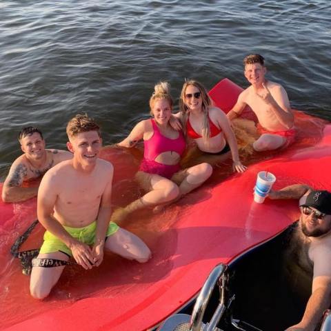 a group of people standing next to a body of water