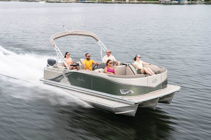 a group of people riding on the back of a boat in the water